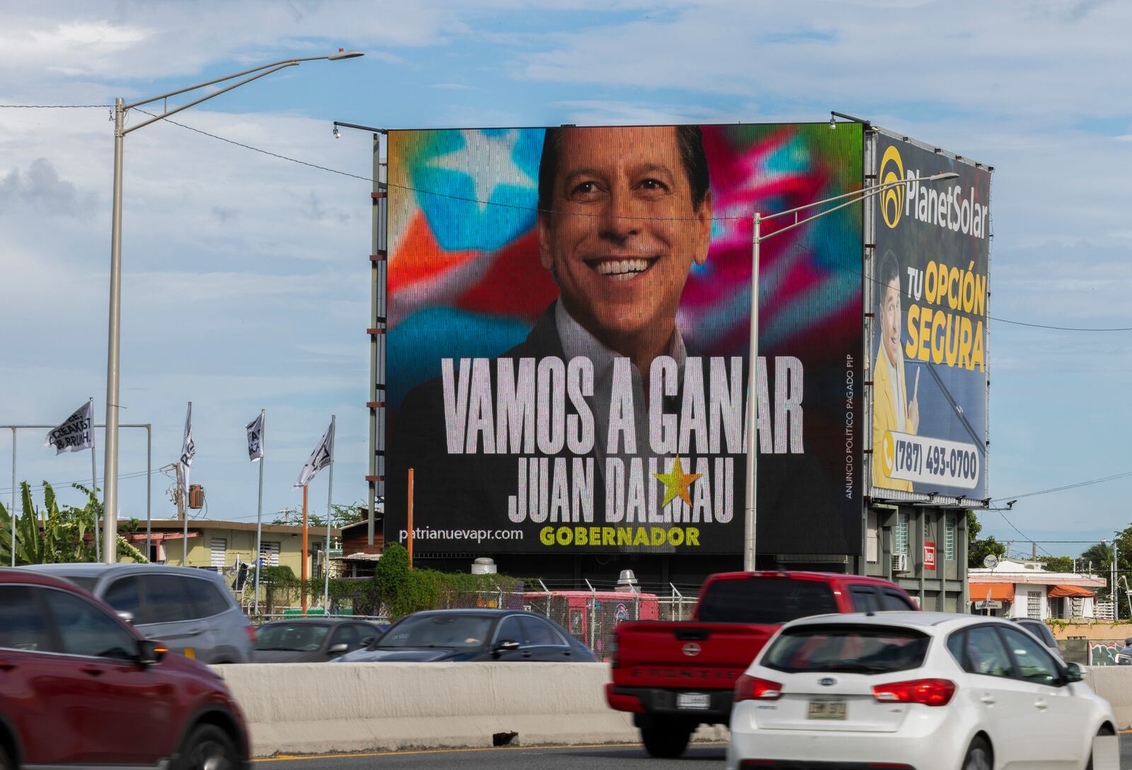 A billboard promoting Puerto Rico’s Independence Party and the Citizen Victory Movement gubernatorial candidate Juan Dalmau towers over a highway, in San Juan, Puerto Rico, Saturday, Nov. 2, 2024.(AP Photo/Alejandro Granadillo)