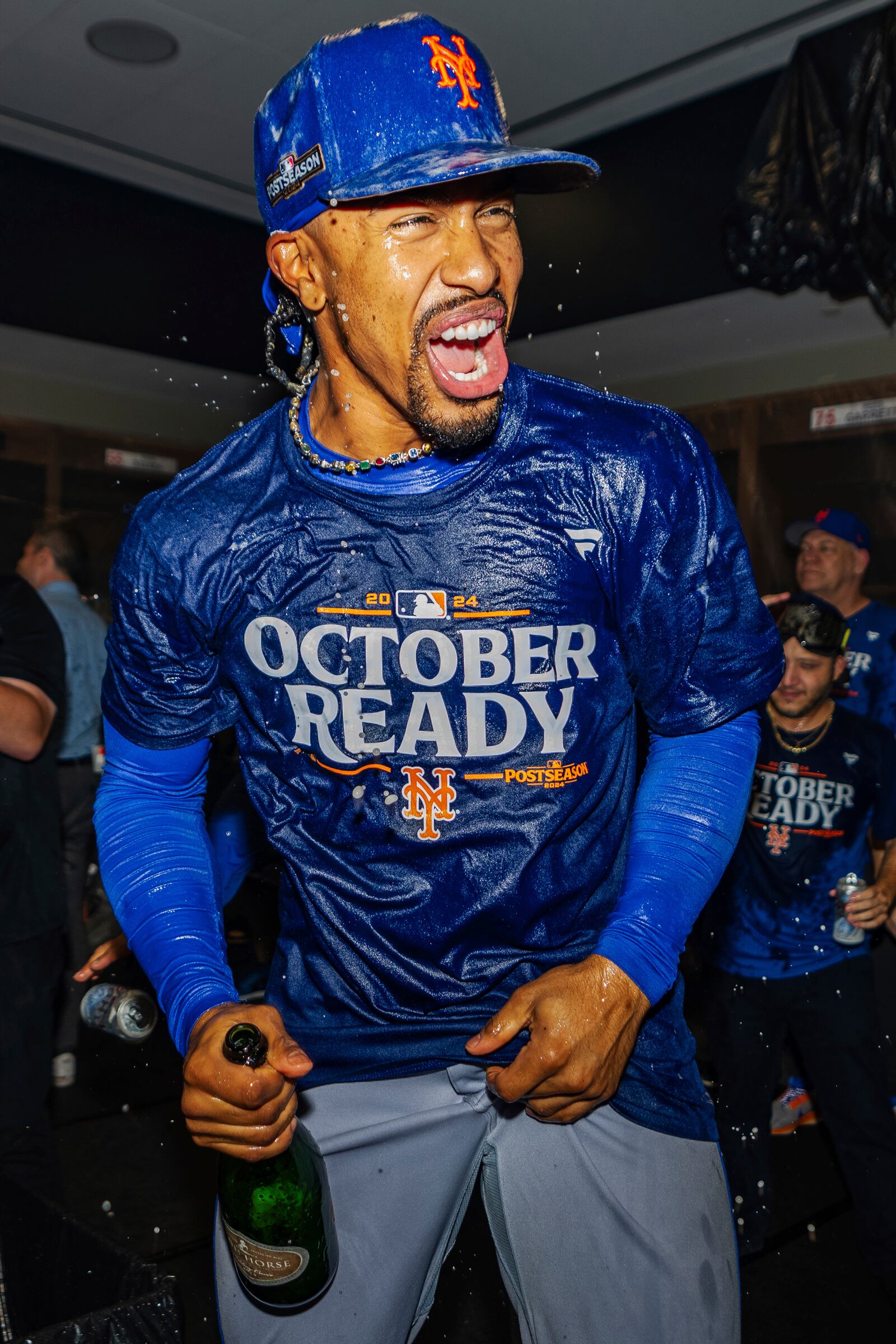 New York Mets shortstop Francisco Lindor celebrates in the locker room after clinching a playoff berth with a victory in the first baseball game of a doubleheader against the Atlanta Braves, Monday, Sept. 30, 2024, in Atlanta. (AP Photo/Jason Allen)