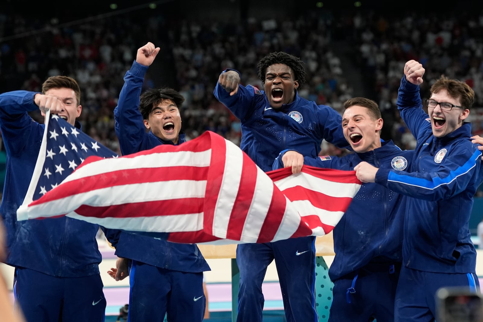 FILE - Team USA from left to right Brody Malone, Asher Hong, Fred Richard, Paul Juda and Stephen Nedoroscik celebrate their bronze medal during the men's artistic gymnastics team finals round at Bercy Arena at the 2024 Summer Olympics, July 29, 2024, in Paris, France. (AP Photo/Abbie Parr, File)