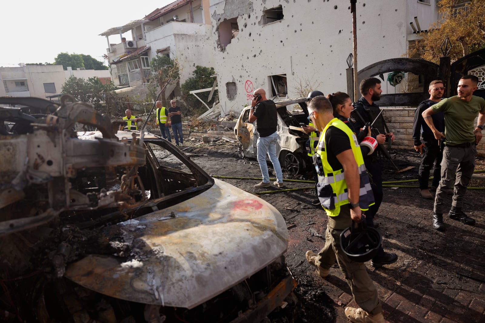 Israeli security forces examine the site hit by a rocket fired from Lebanon, in Kiryat Bialik, northern Israel, on Sunday, Sept. 22, 2024. (AP Photo//Ariel Schalit)