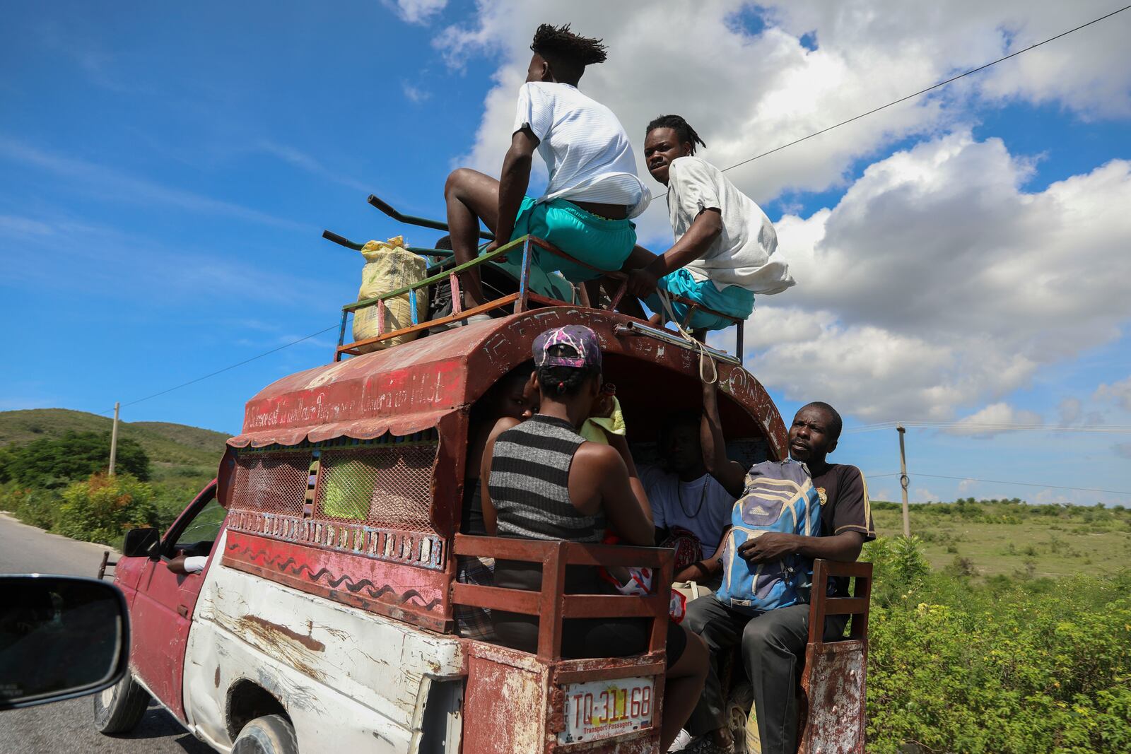 People ride public transportation known as a tap-tap in Pont-Sonde, Haiti, Tuesday, Oct. 8, 2024, days after a deadly gang attack on the town. (AP Photo/Odelyn Joseph)