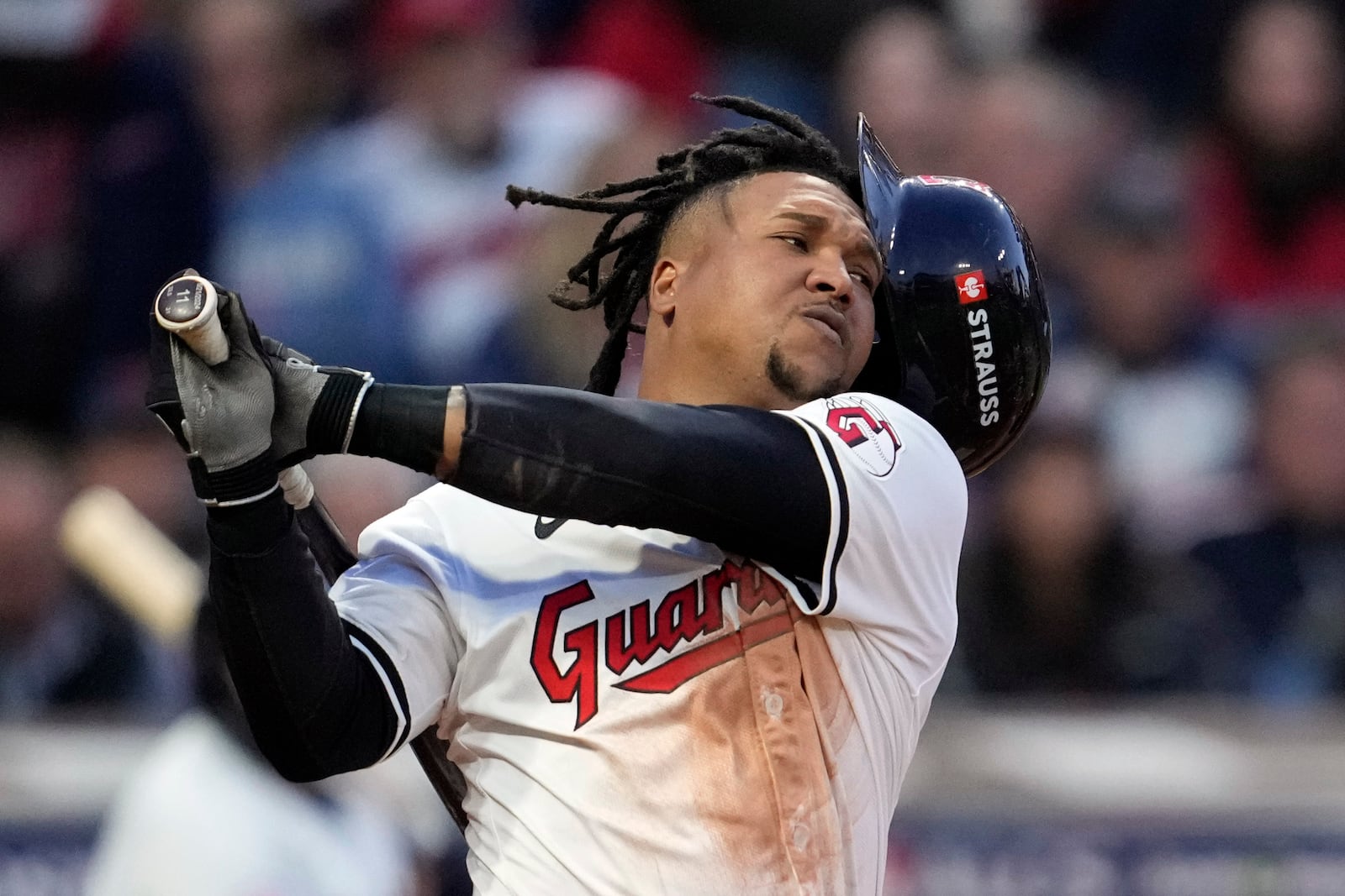 Cleveland Guardians' José Ramírez loses his helmet as he swings for a strike against the New York Yankees during the fifth inning in Game 3 of the baseball AL Championship Series Thursday, Oct. 17, 2024, in Cleveland.(AP Photo/Godofredo Vásquez )