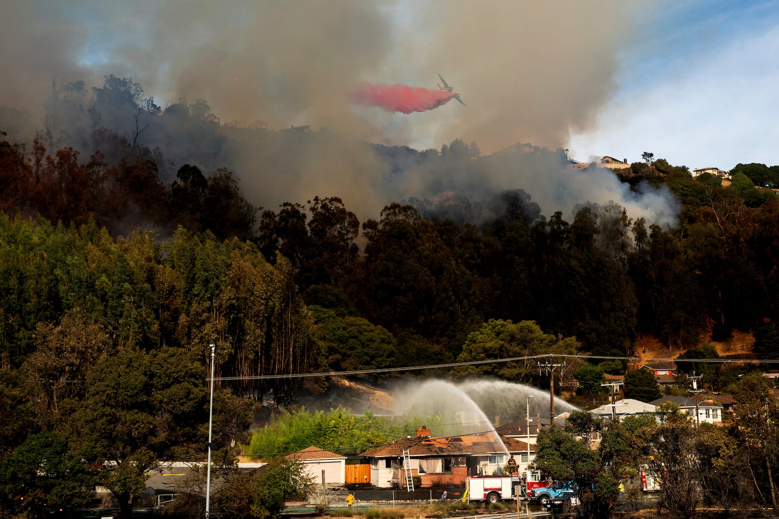 A grass fire burns above Interstate 580 in Oakland, Calif., on Friday, Oct. 18, 2024. (AP Photo/Noah Berger)