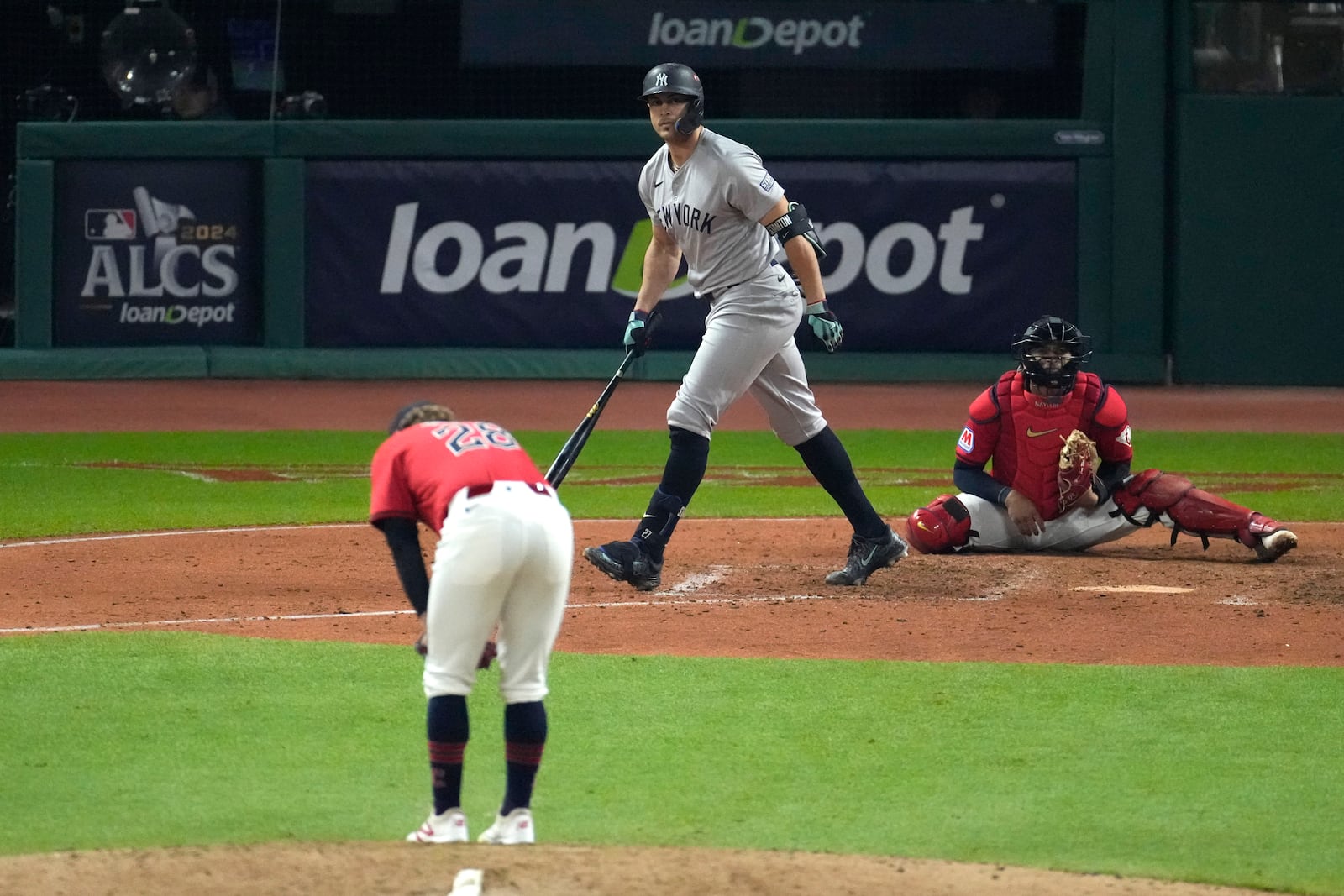 New York Yankees' Giancarlo Stanton, center, watches his two-run home run off Cleveland Guardians starting pitcher Tanner Bibee (28) during the sixth inning in Game 5 of the baseball AL Championship Series Saturday, Oct. 19, 2024, in Cleveland. (AP Photo/Jeff Roberson)