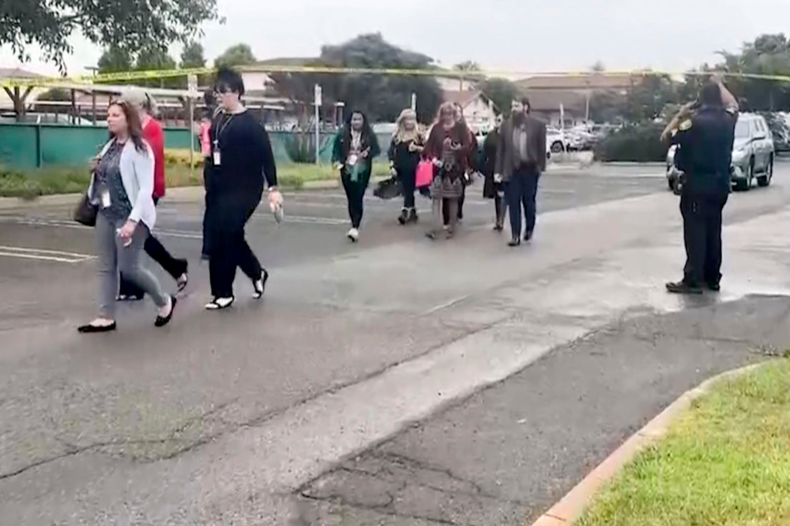 In this still image from video provided by KEYT, people walk past a police barricade following an explosion at the Santa Maria Courthouse in Santa Maria, Calif., Wednesday, Sept. 25, 2024. (KEYT via AP)