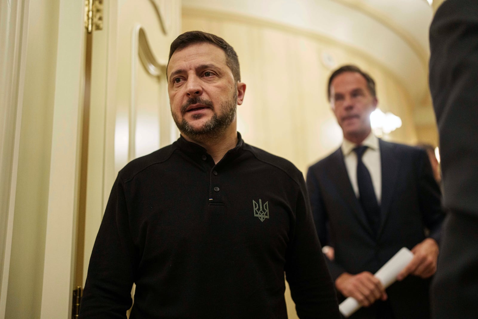 Ukrainian President Volodymyr Zelenskyy, left, and NATO Secretary General Mark Rutte walk in a corridor ahead of a press conference in Kyiv, Ukraine, Thursday Oct. 3, 2024. (AP Photo/Evgeniy Maloletka)