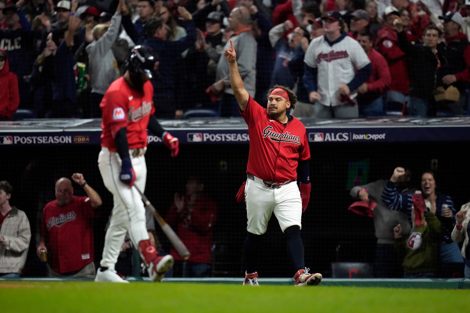 Cleveland Guardians' Josh Naylor celebrates after scoring on a RBI double by his brother, Bo Naylor, during the second inning in Game 5 of the baseball AL Championship Series against the New York Yankees Saturday, Oct. 19, 2024, in Cleveland. (AP Photo/Sue Ogrocki)