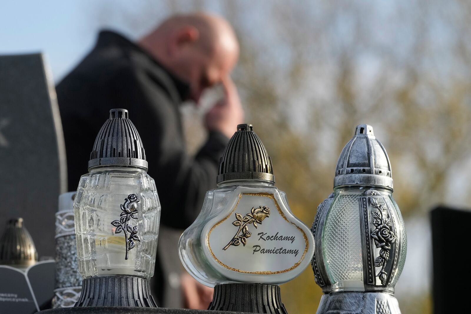 Candles burn in All Saints' Day, a time for reflecting on those who have died, on Friday Nov. 1, 2024, in Zakroczym near Warsaw, Poland. (AP Photo/Czarek Sokolowski)