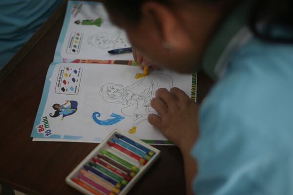 A student fills a colouring book at a school for victims of Agent Orange in Da Nang, Vietnam, March 7, 2025. (AP Photo/Aniruddha Ghosal)