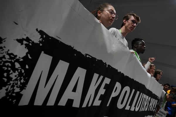 Activists participate in a demonstration for climate finance at the COP29 U.N. Climate Summit, Saturday, Nov. 16, 2024, in Baku, Azerbaijan. (AP Photo/Peter Dejong)