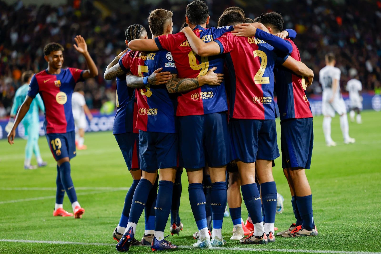 Barcelona's Robert Lewandowski, centre, celebrates after scoring his side's fourth goal during the Champions League soccer match between Barcelona and Young Boys at the Lluis Companys Olympic Stadium in Barcelona, Spain, Tuesday, Oct. 1, 2024. (AP Photo/Joan Monfort)