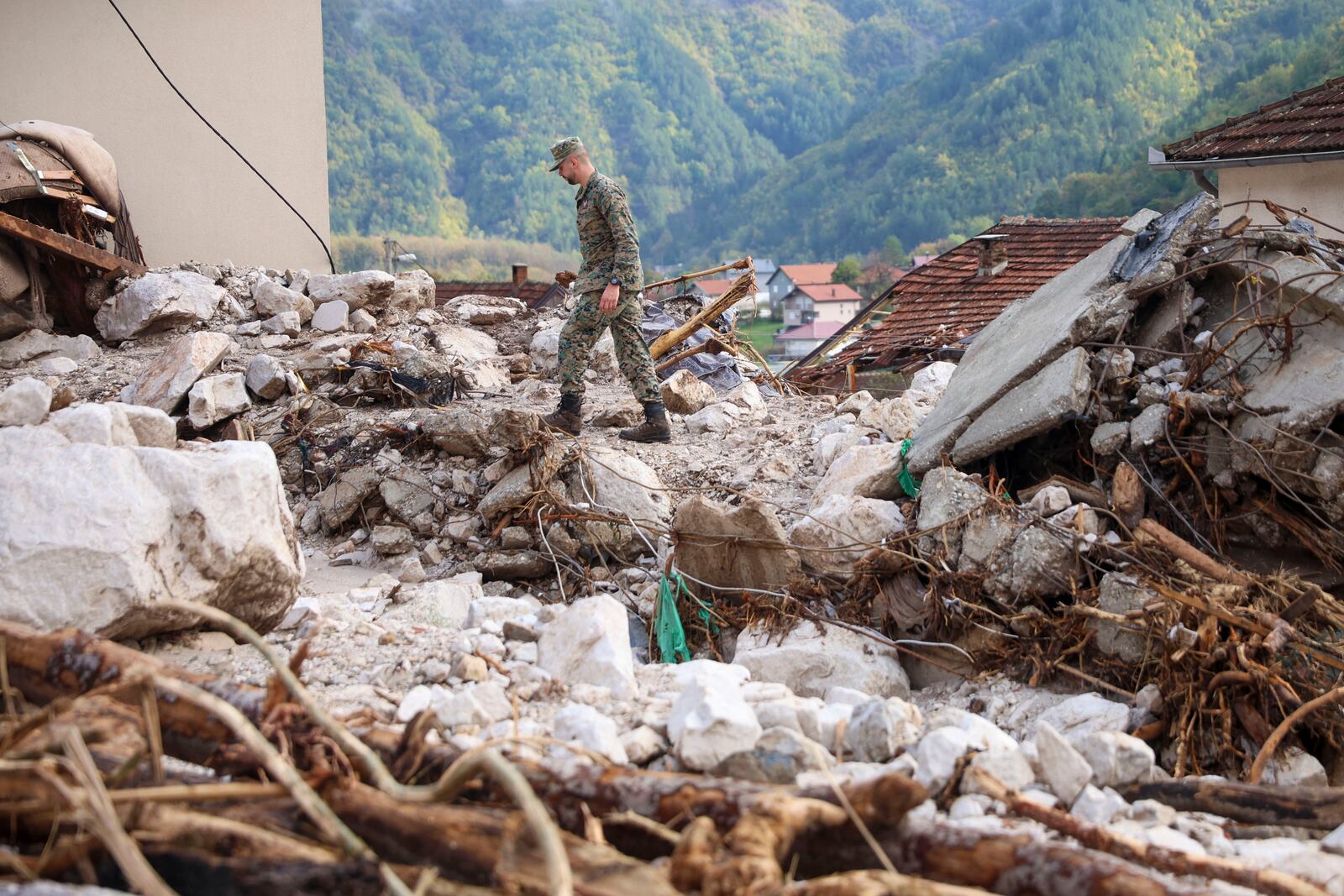 A Bosnian soldier inspects a damaged house after floods and landslides in the village of Donja Jablanica, Bosnia, Saturday, Oct. 5, 2024. (AP Photo/Armin Durgut)