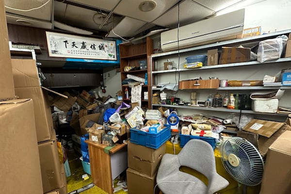 Piles of boxes with books and other belongings are seen inside the shuttered secondhand bookstore "Wang Pangzi" in Ningbo, in eastern China's Zhejiang province, Oct. 9, 2024. (AP Photo/Dake Kang)