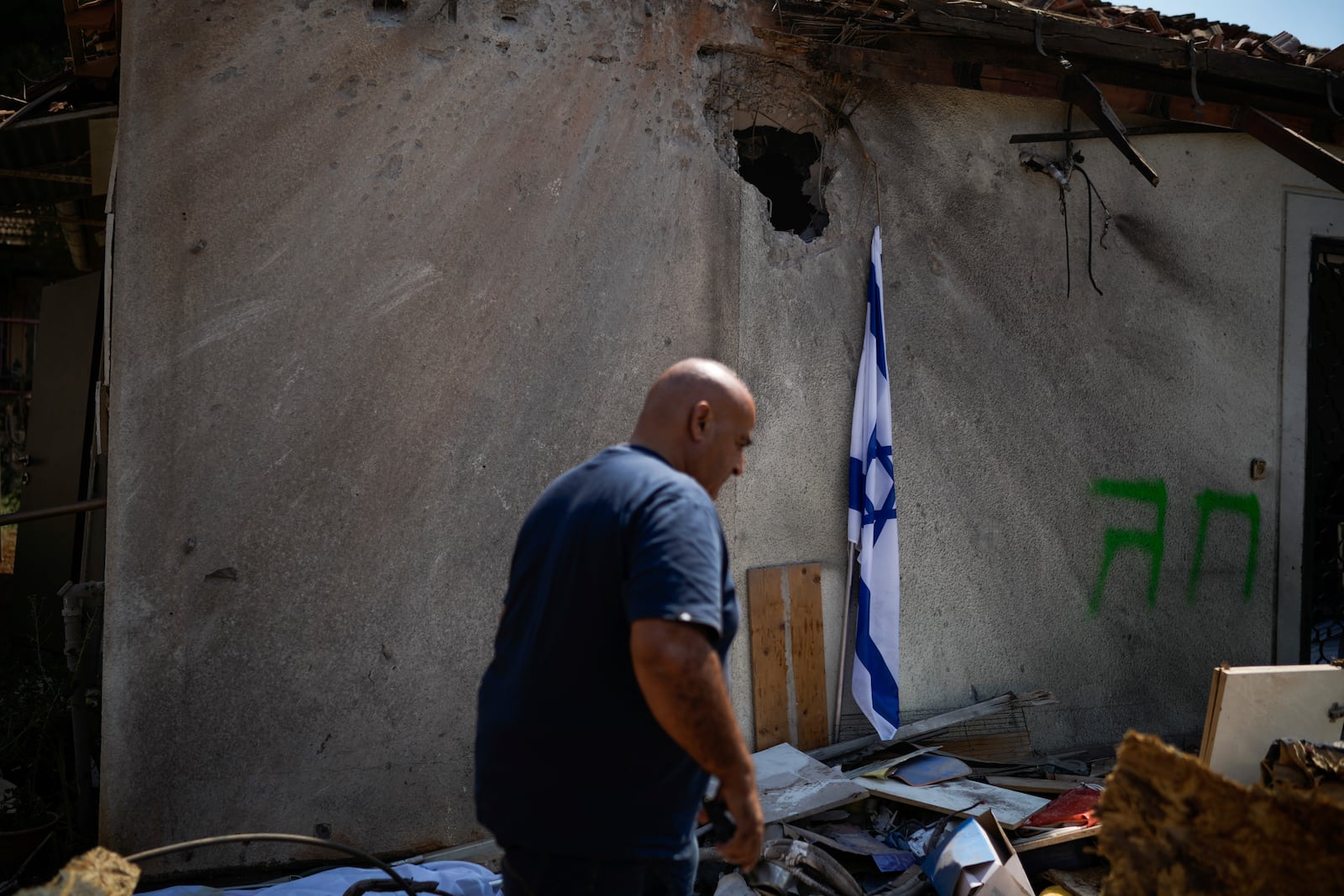 A man looks at a damaged house that was hit by a rocket fired from Lebanon, near Safed, northern Israel, on Wednesday, Sept. 25, 2024. (AP Photo//Leo Correa)