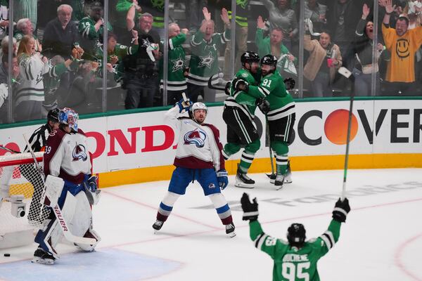 Colorado Avalanche goaltender Mackenzie Blackwood (39) and Samuel Girard, center, look on as the Dallas Stars celebrate a goal scored by Dallas Stars' Mikko Rantanen, rear, in the third period in Game 7 of a first-round NHL hockey playoff series Saturday, May 3, 2025, in Dallas. (AP Photo/Julio Cortez)