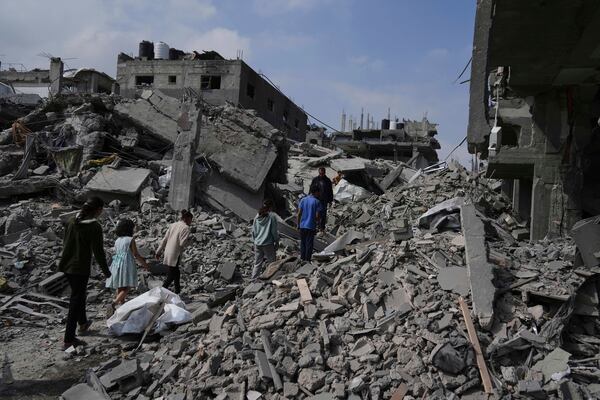 Palestinians walk in the rubbles after an Israeli army airstrike in Beit Lahia, northern Gaza Strip, Monday, April 28, 2025. (AP Photo/Jehad Alshrafi)