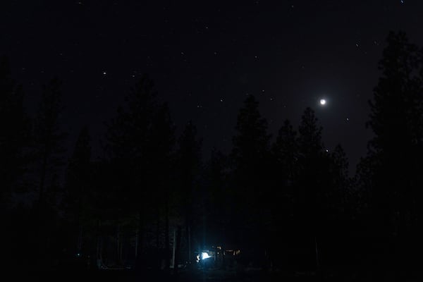 Greg Bishop works to get an RV to start at a homeless encampment in Deschutes National Forest, Wednesday, April 30, 2025 near Bend, Ore. (AP Photo/Jenny Kane)