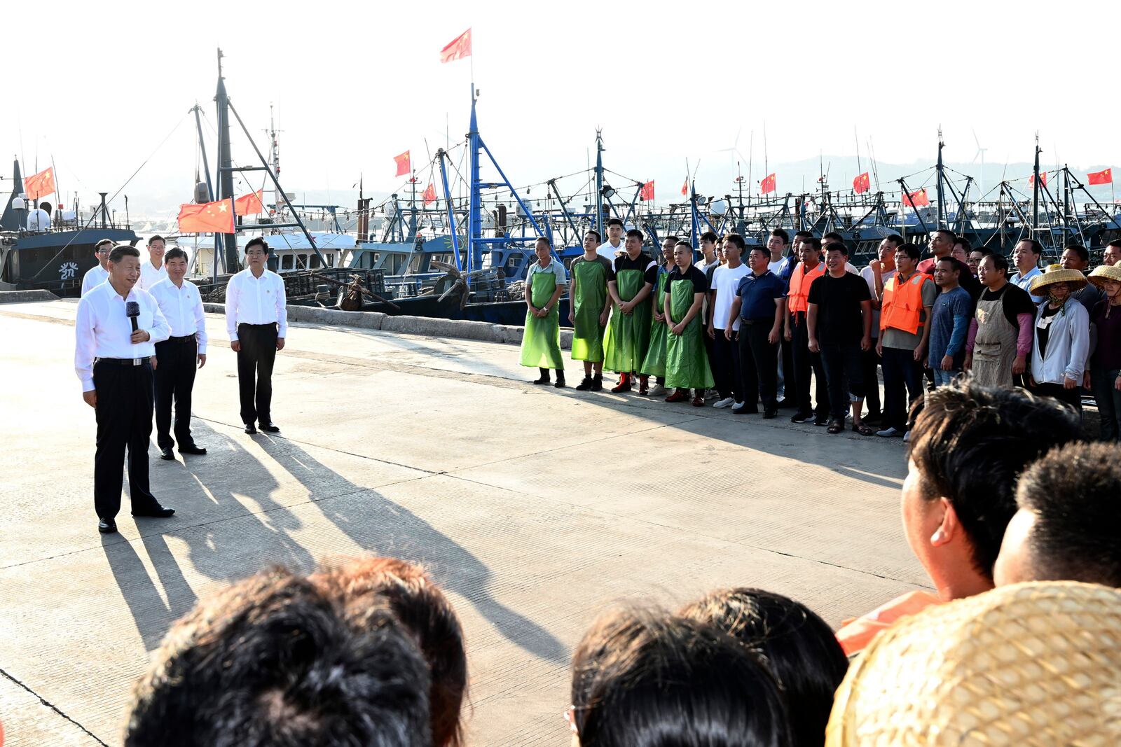 In this photo released by Xinhua News Agency, Chinese President Xi Jinping, left, visits Aojiao Village of Dongshan County in the city of Zhangzhou during an inspection tour in southeastern China's Fujian province on Tuesday, Oct. 15, 2024. (Xie Huanchi/Xinhua via AP)