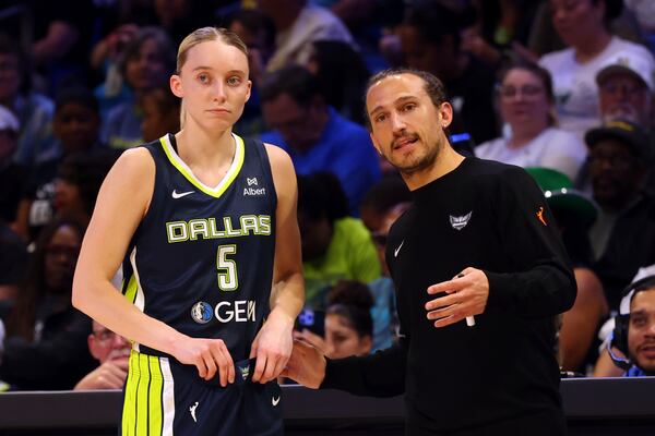 CORRECTS YEAR TO 2025 NOT 2020 - Dallas Wings guard Paige Bueckers (5) talks with head coach Chris Koclanes, right, in the first half of a WNBA basketball game against the Minnesota Lynx, Friday, May 16, 2025, in Arlington, Texas. (AP Photo/Richard W. Rodriguez)