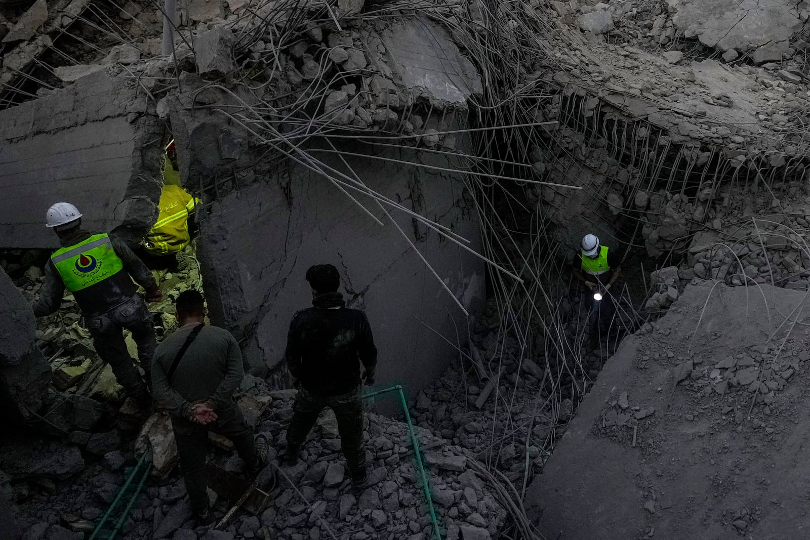 Rescue workers search for victims at a house hit in an Israeli airstrike in Baalchmay village east of Beirut, Lebanon, Tuesday, Nov. 12, 2024. (AP Photo/Hassan Ammar)