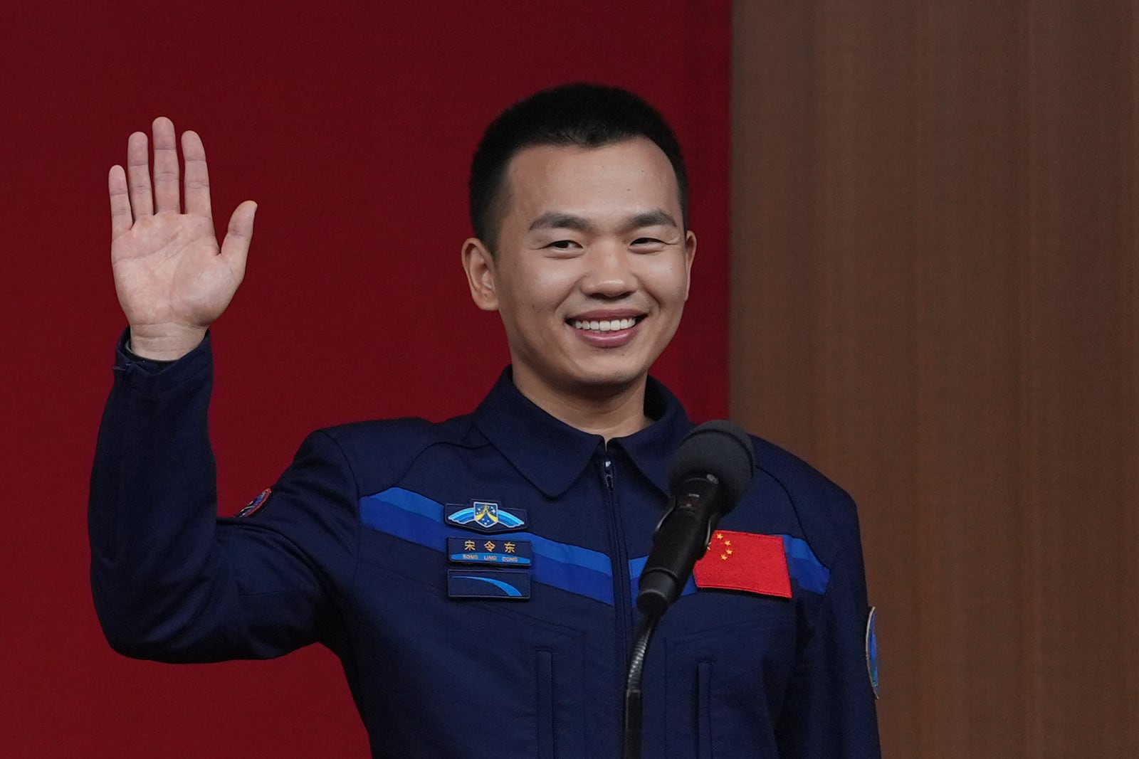 Chinese astronaut Song Lingdong waves during a press conference ahead of a Shenzhou-19 mission at the Jiuquan Satellite Launch Center in northwestern China on Tuesday, Oct. 29, 2024. (AP Photo/Ng Han Guan)