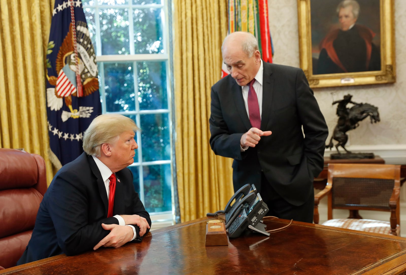 FILE - President Donald Trump listens to White House Chief of Staff John Kelly, right, in the Oval Office of the White House in Washington, Oct. 10, 2018. (AP Photo/Pablo Martinez Monsivais, File)