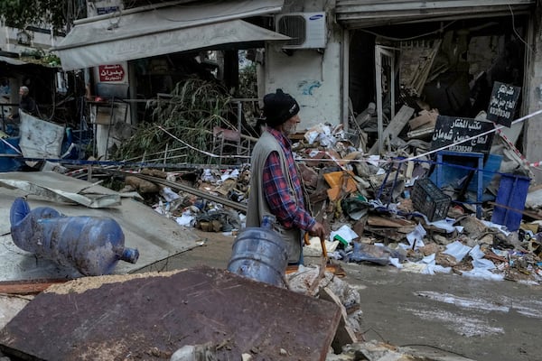 A man passes in front of a destroyed building hit on Monday evening by an Israeli airstrike in central Beirut, Lebanon, Tuesday, Nov. 19, 2024. (AP Photo/Bilal Hussein)