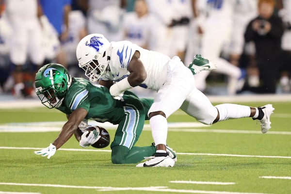 Memphis defensive back Kourtlan Marsh (0) defends a pass intended for Tulane wide receiver Mario Williams (4) in the second half of an NCAA college football game in New Orleans, Thursday, Nov. 28, 2024. (AP Photo/Peter Forest)