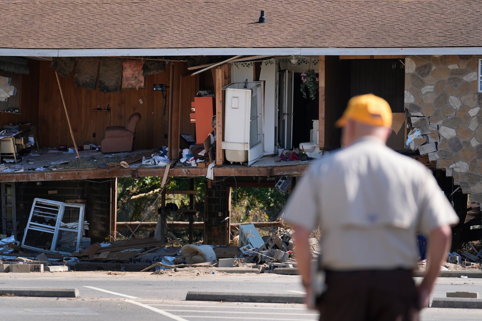 Paul Shaver looks a a building destroyed in the aftermath of Hurricane Helene Saturday, Oct. 5, 2024, in Newport, Tenn. (AP Photo/Jeff Roberson)