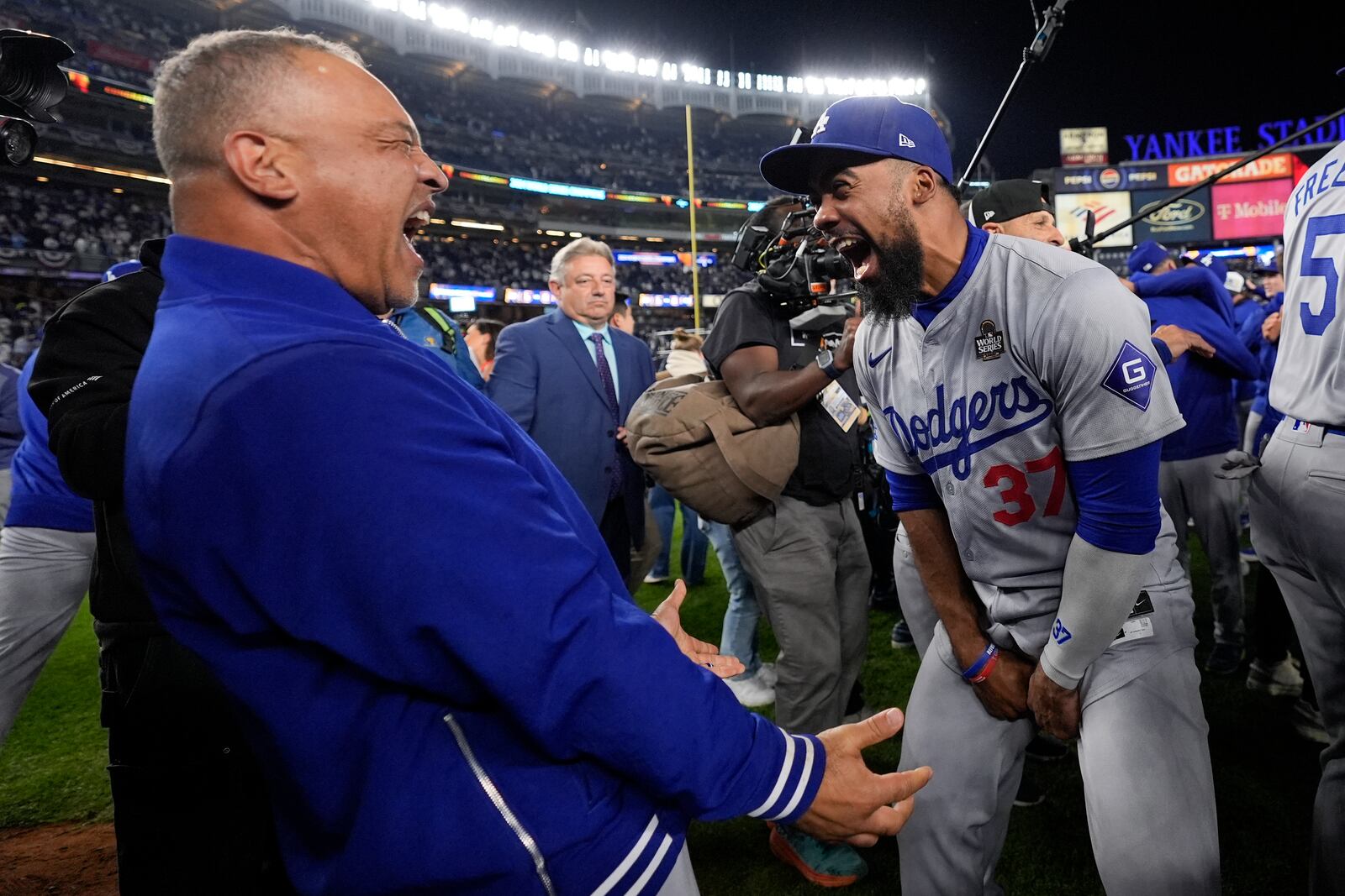 Los Angeles Dodgers manager Dave Roberts and Teoscar Hernández celebrate their win against the New York Yankees in Game 5 to win the baseball World Series, Wednesday, Oct. 30, 2024, in New York. (AP Photo/Ashley Landis)