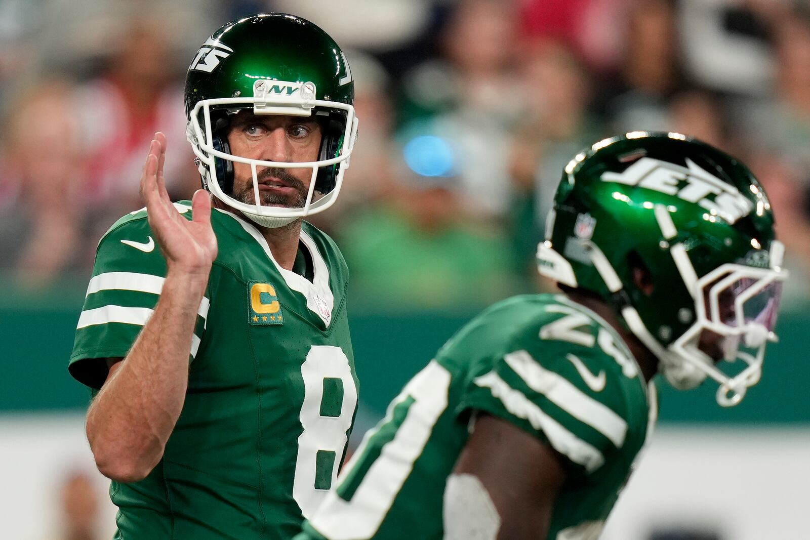 New York Jets quarterback Aaron Rodgers (8) motions on the line of scrimmage against the New England Patriots during the first quarter of an NFL football game, Thursday, Sept. 19, 2024, in East Rutherford, N.J. (AP Photo/Seth Wenig)