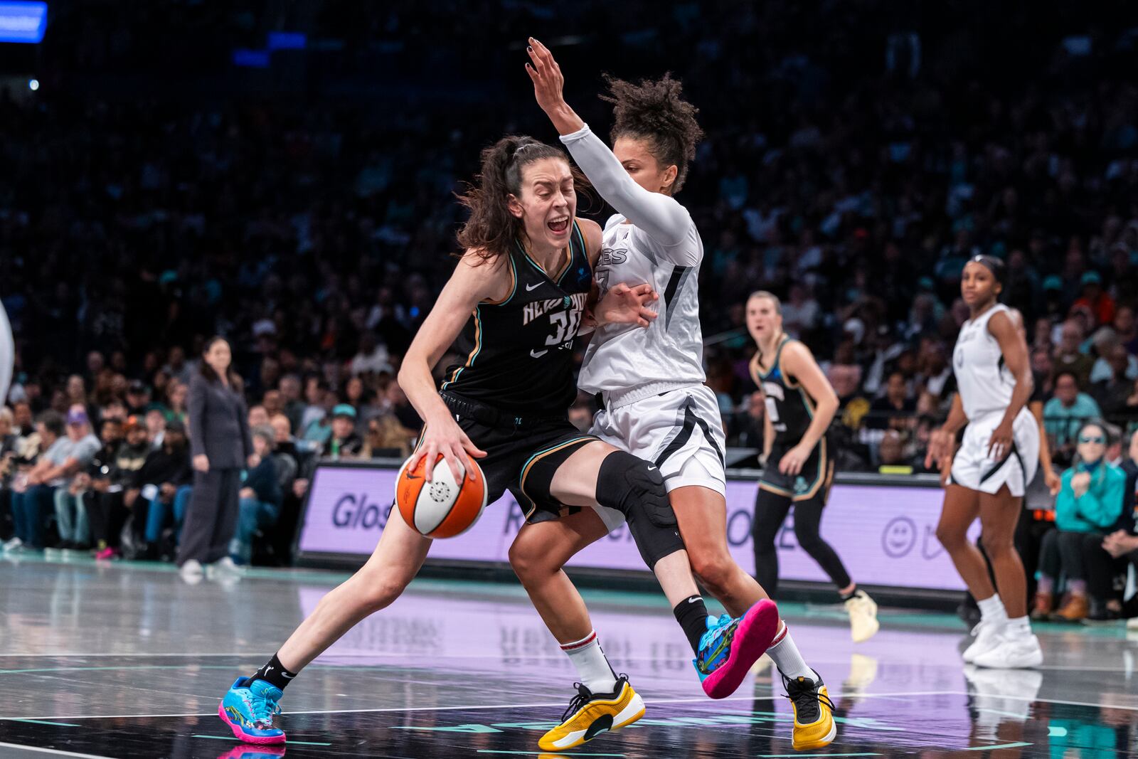 New York Liberty forward Breanna Stewart (30) is defended by Las Vegas Aces forward Alysha Clark (7) during the first half of a WNBA basketball second-round playoff game, Sunday, Sept. 29, 2024, in New York. (AP Photo/Corey Sipkin)