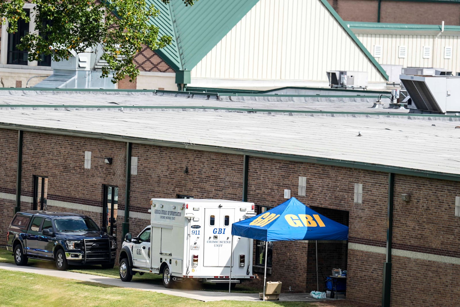 Georgia Bureau of Investigation staff move through an entrance to Apalachee High School after Wednesday's multiple shooting, Thursday, Sept. 5, 2024, in Winder, Ga. (AP Photo/Mike Stewart)WLD