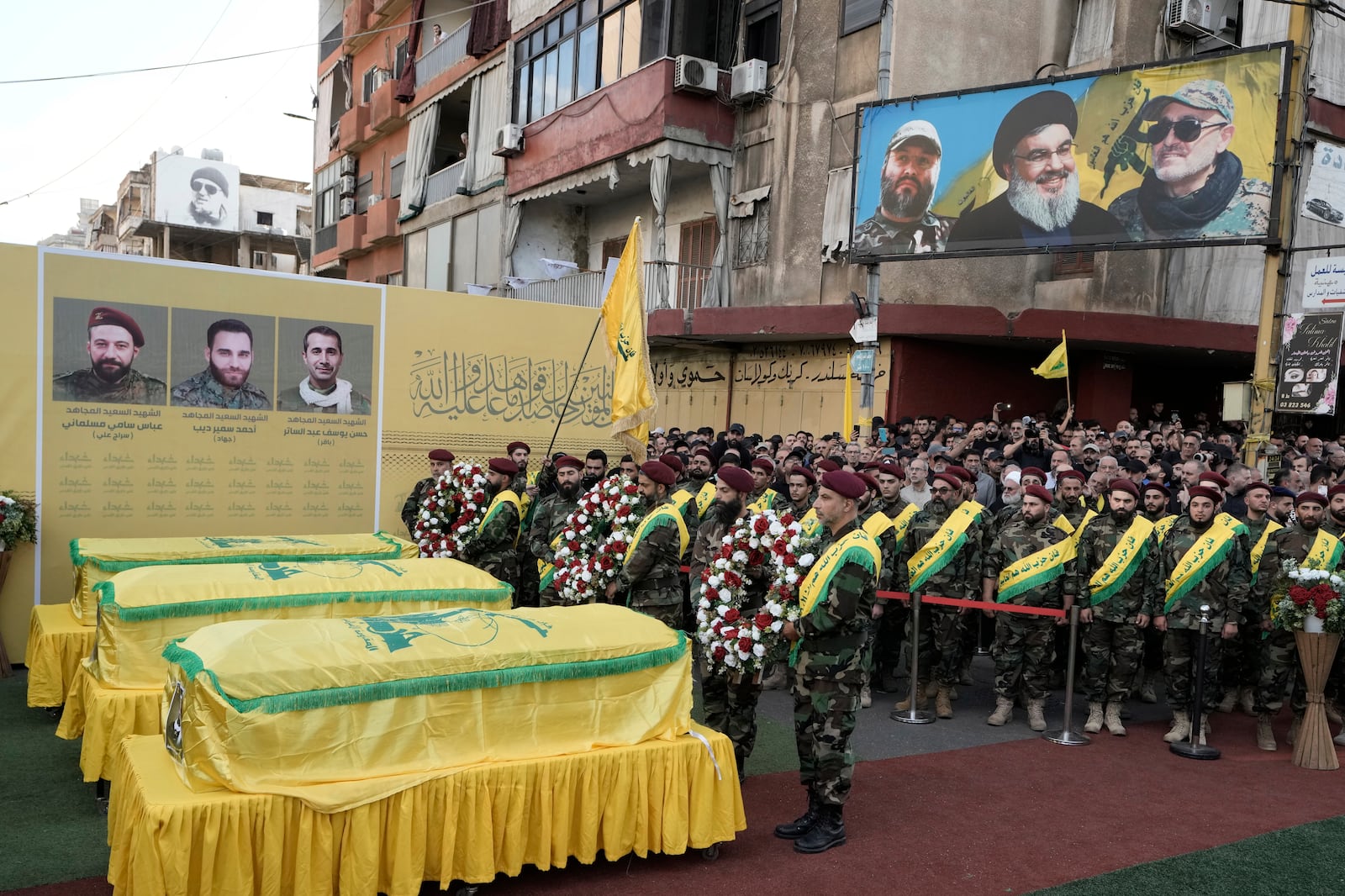 Hezbollah fighters carry wreaths during the funeral procession of their comrades who were killed in Friday's Israeli strike, in the southern suburb of Beirut, Saturday, Sept. 21, 2024. (AP Photo/Bilal Hussein)