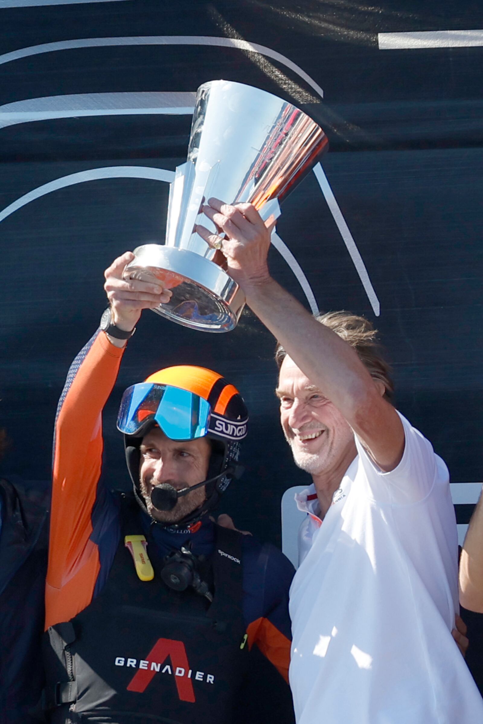 INEOS Britannia Chairman Jim Ratcliffe, right, and team skipper Ben Ainslie crew celebrate their team victory against the Luna Rosa Prada Pirelli's sailing team during the Louis Vuitton Cup Final Day 7 at the Barcelona's coast, Spain, Friday, Oct. 4, 2024. (AP Photo/Joan Monfort)