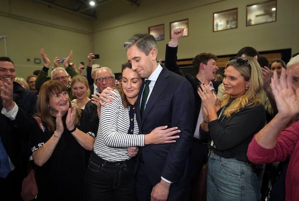 Irish premier Simon Harris is hugged by his wife Caoimhe after being re-elected to the Dail parliament as a TD for Wicklow on the first count at the election count centre at Shoreline Leisure Greystones in County Wicklow, south of Dublin, Ireland, after the General Election, Saturday, Nov. 30, 2024. (Niall Carson/PA via AP)