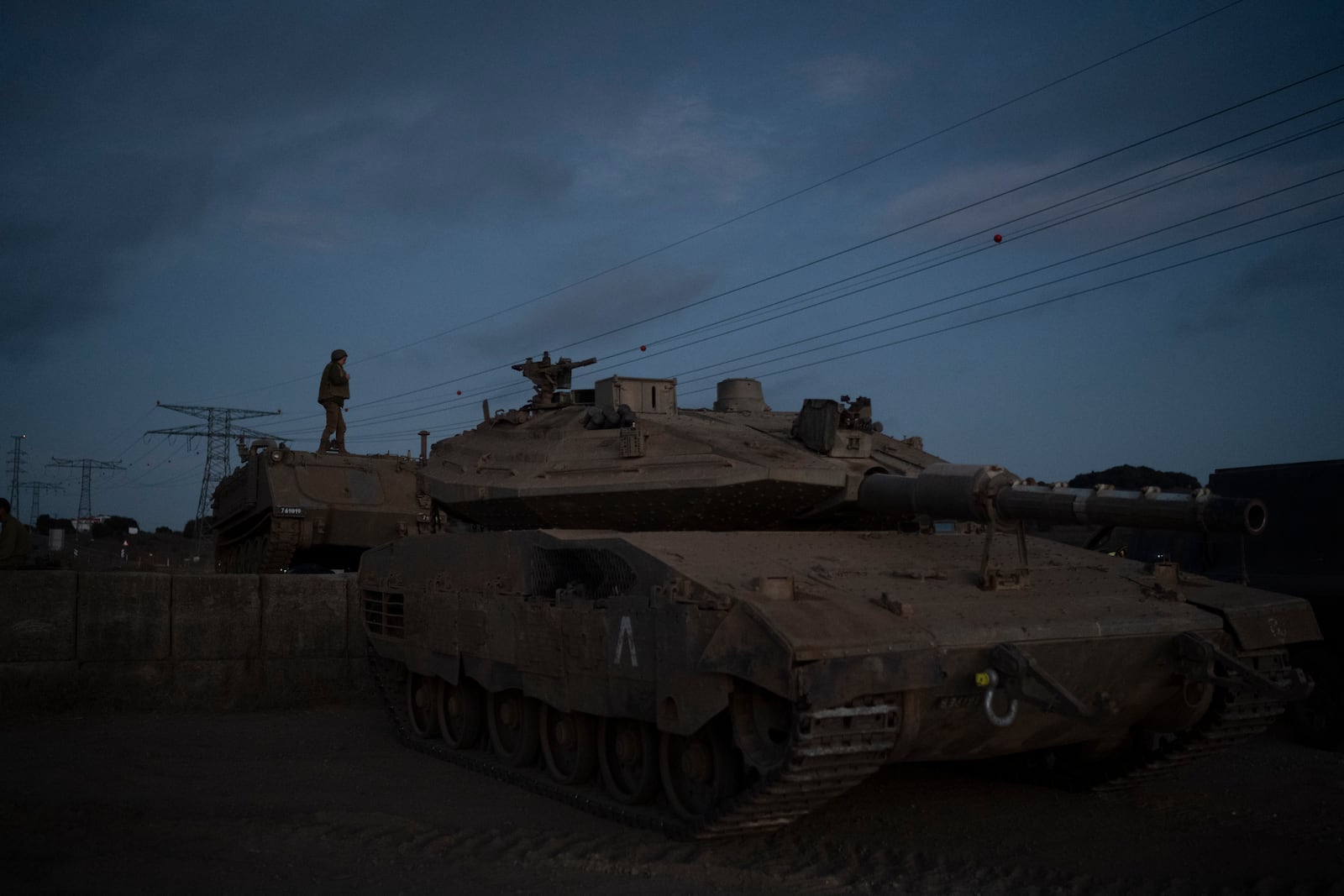 An Israeli soldier stands on the top an armored vehicle on an area in the Israeli-annexed Golan Heights, Thursday, Sept. 19, 2024. (AP Photo/Leo Correa)