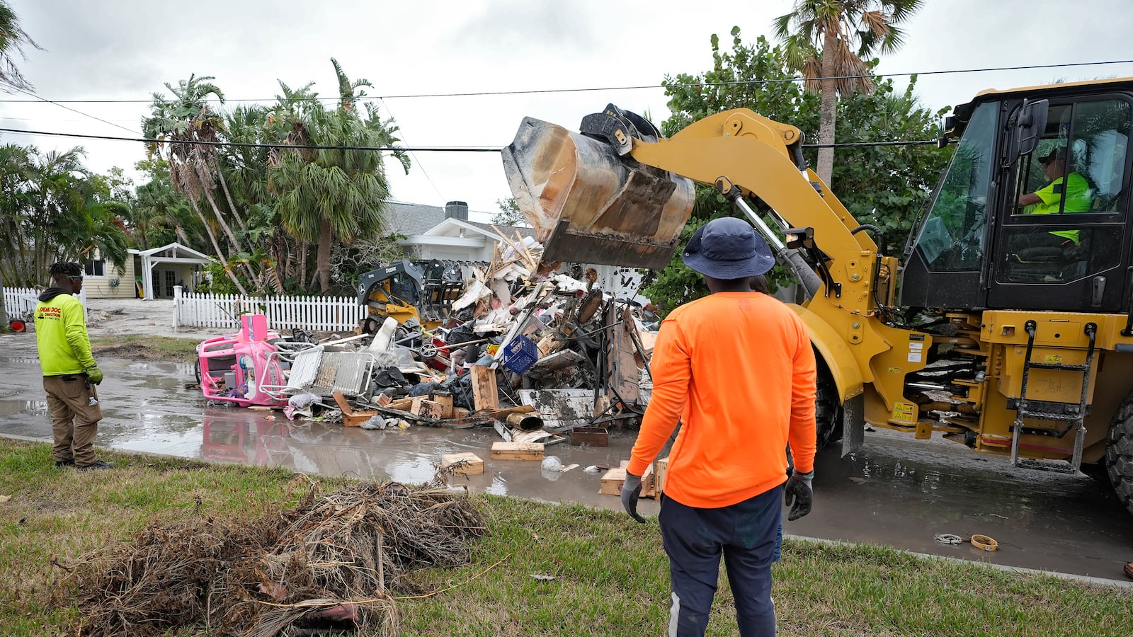 Salvage works remove debris from Hurricane Helene flooding along the Gulf of Mexico Monday, Oct. 7, 2024, in Clearwater Beach, Fla. Crews are working to remove the debris before Hurricane Milton approaches Florida's west coast. (AP Photo/Chris O'Meara)