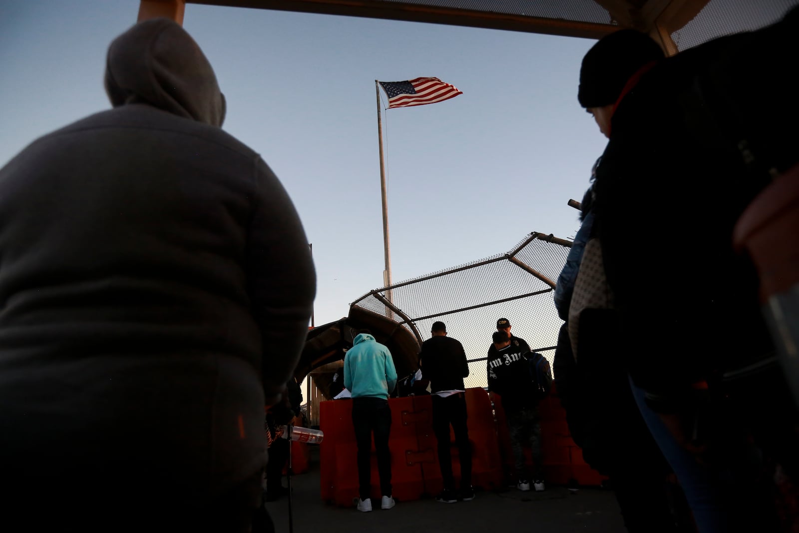 Migrants line up to present to U.S. agents documents requesting an appointment to apply for asylum at the Paso del Norte international bridge, in Ciudad Juarez, Mexico, Tuesday, Nov 5, 2024. (AP Photo/Christian Chavez)