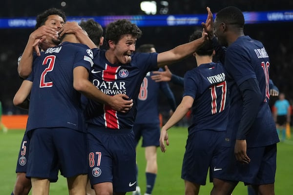 PSG's Achraf Hakimi, left, celebrates with teammates after scoring his sides second goal during the Champions League semifinal, second leg soccer match between Paris Saint-Germain and Arsenal at the Parc des Princes in Paris, Wednesday, May 7, 2025. (AP Photo/Thibault Camus)