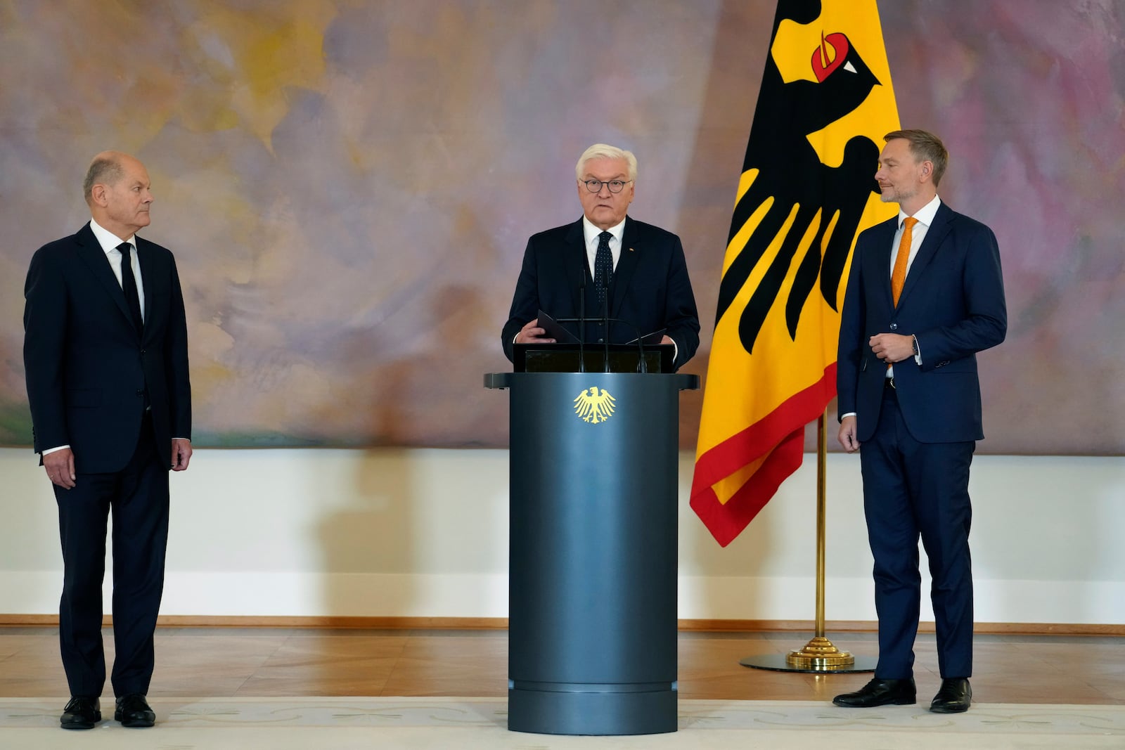 Germany's Federal President Frank-Walter Steinmeier, center, presents Christian Lindner, former Federal Minister of Finance, right, with his certificate of dismissal with German Chancellor Olaf Scholz, at left, at Bellevue Palace, in Berlin, Thursday, Nov. 7, 2024. (Kay Nietfeld/dpa via AP)