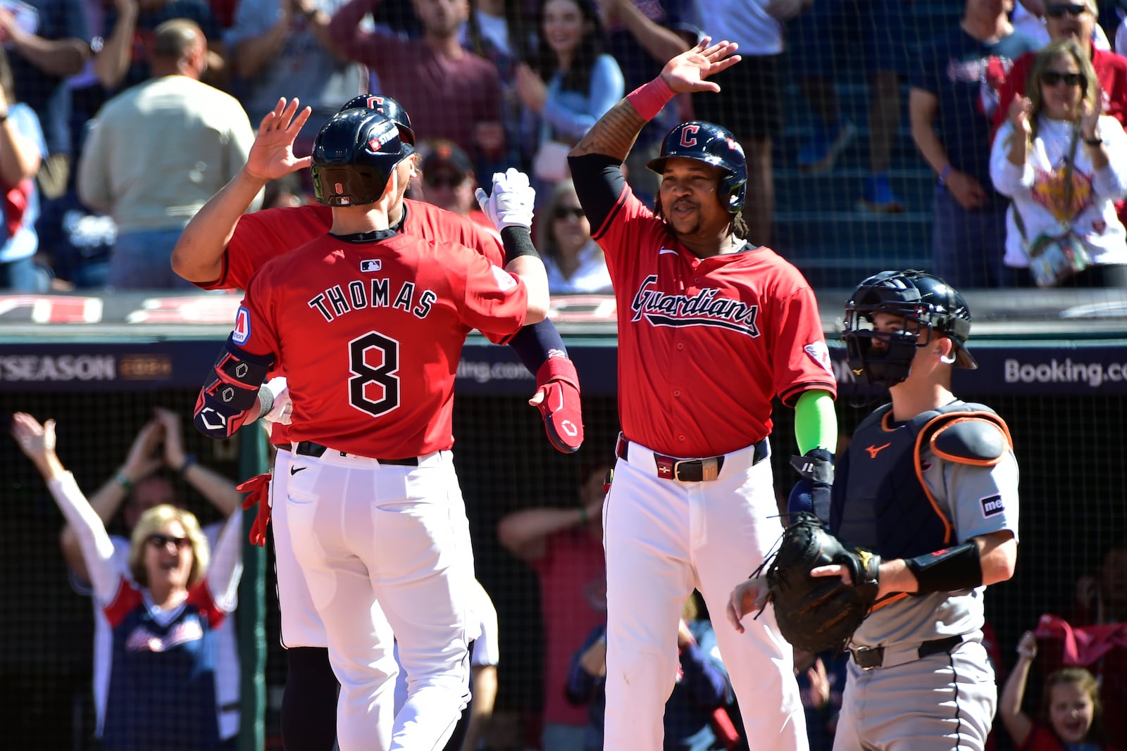 Cleveland Guardians' Lane Thomas (8) is greeted at the plate by teammates Josh Naylor, rear and third baseman Jose Ramirez, second right, in front of Detroit Tigers catcher Jake Rogers, right, after hitting a home run in the first inning during Game 1 of baseball's AL Division Series, Saturday, Oct. 5, 2024, in Cleveland. (AP Photo/Phil Long)