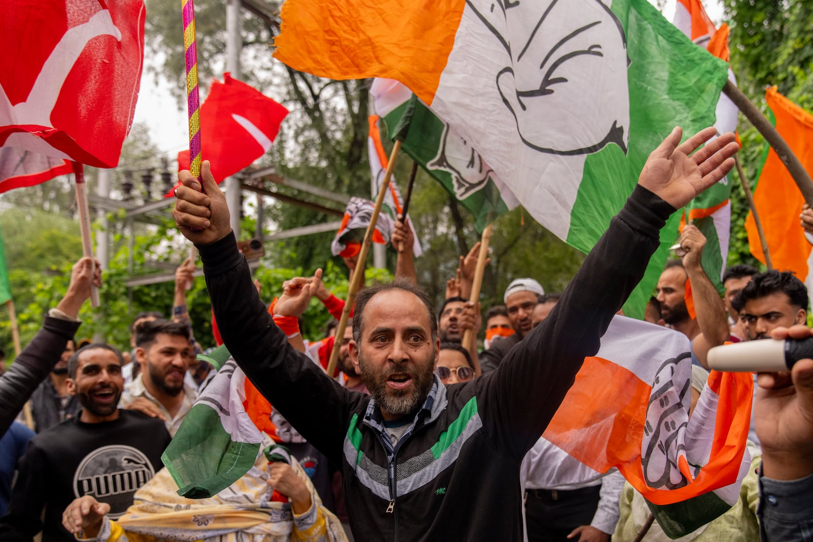 Supporters of National Conference party shout slogans as they celebrate early leads in the election for a local government in Indian controlled Kashmir, Srinagar, Tuesday, Oct. 8, 2024. (AP Photo/Dar Yasin)