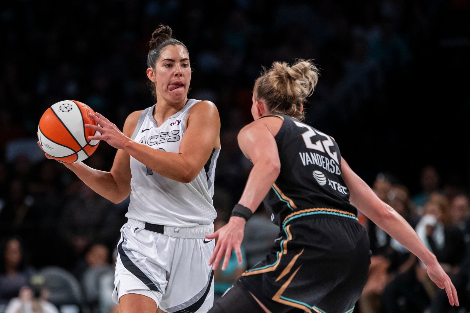 Las Vegas Aces guard Kelsey Plum, left, looks to pass around New York Liberty guard Courtney Vandersloot (22) during the second half of a WNBA basketball second-round playoff game, Sunday, Sept. 29, 2024, in New York. (AP Photo/Corey Sipkin)