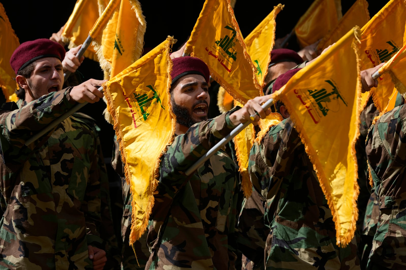 Hezbollah members attend the funeral of two of their comrades who were killed on Wednesday when a handheld device exploded, during a funeral procession in the southern suburbs of Beirut, Thursday, Sept. 19, 2024. (AP Photo/Hussein Malla)