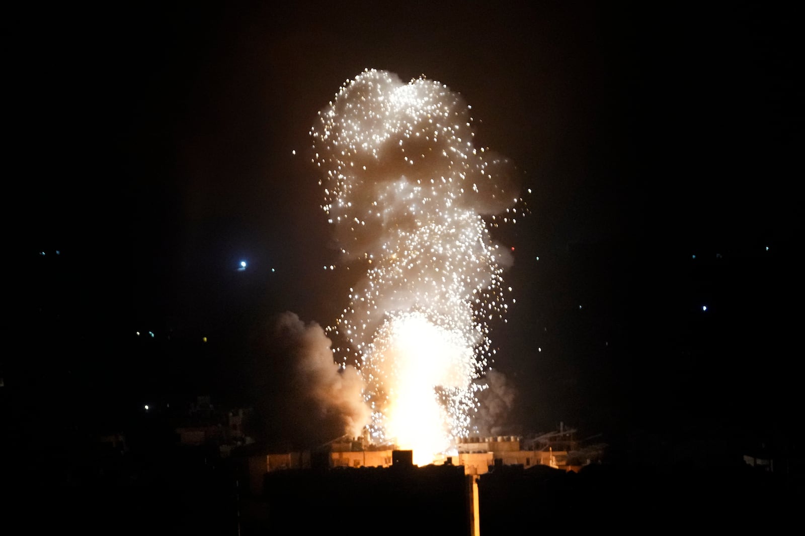 Flames and smoke rise from an Israeli airstrike in Dahiyeh, Beirut, Lebanon, early Sunday, Oct. 6, 2024. (AP Photo/Hussein Malla)