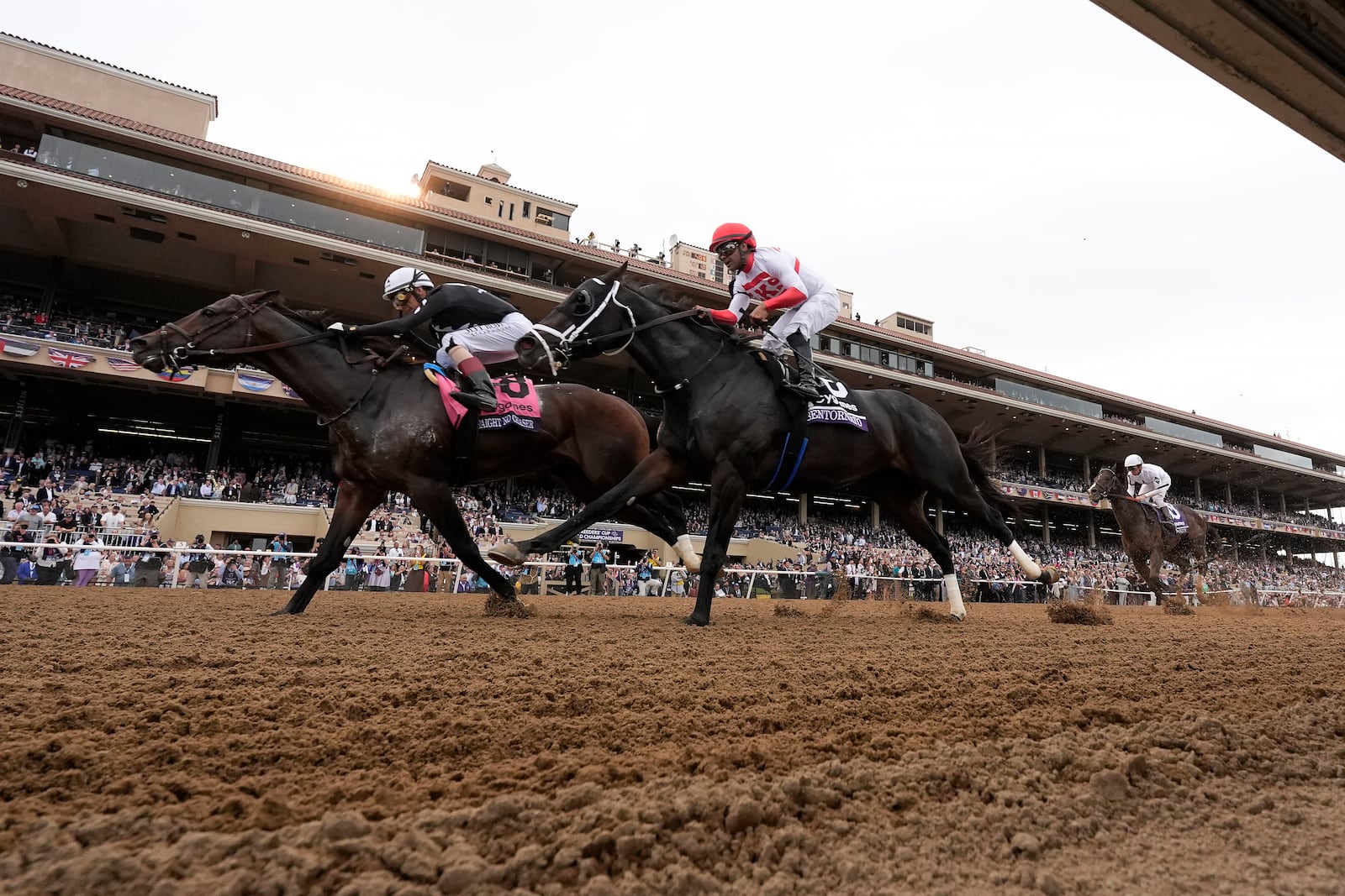 John Velazquez rides Straight No Chaser, left, to victory past Luis Saez, riding Bentornato, in the Breeders' Cup Sprint horse race in Del Mar, Calif., Saturday, Nov. 2, 2024. (AP Photo/Gregory Bull)