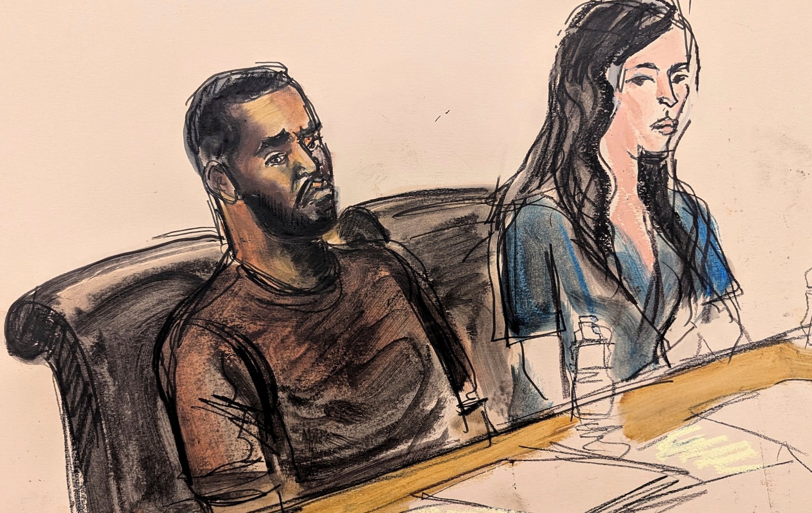 Depicted in this courtroom sketch, Sean "Diddy" Combs, left, sits at the defense table with one of his attorneys, Teny Garagos, during his bail hearing, Wednesday, Sept. 18, 2024, in New York. (Elizabeth Williams via AP)