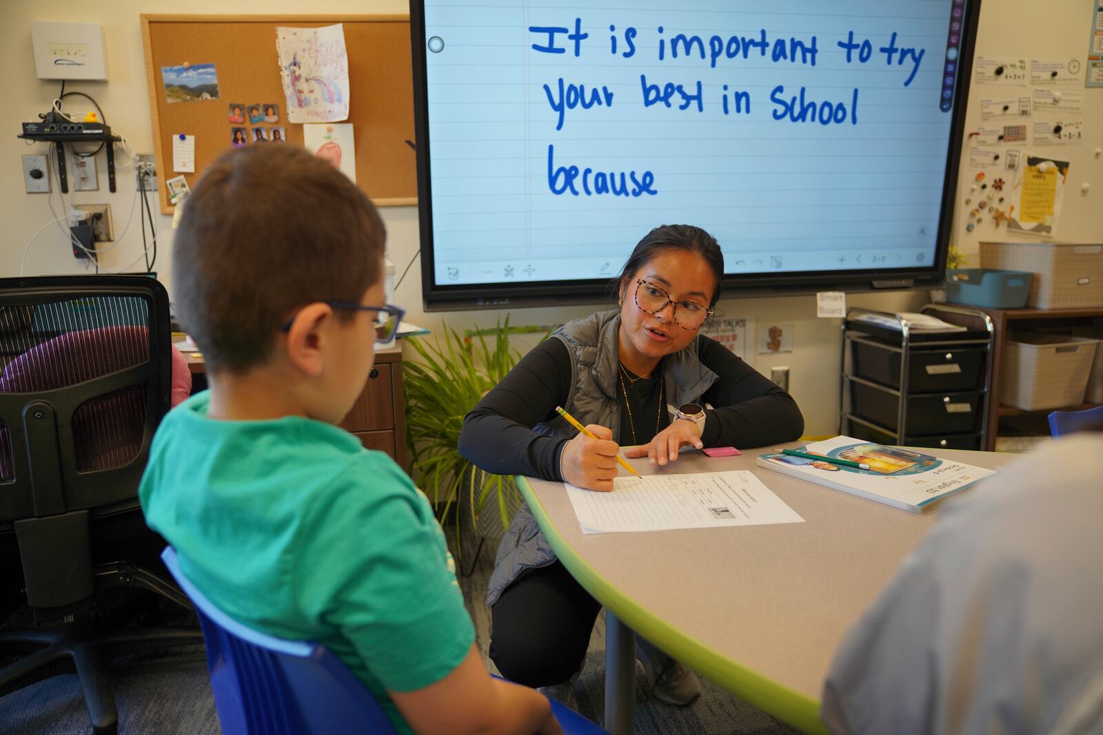 TahSoGhay Collah, right, teaches a third-grade English learners class at the 700-student intermediate school that serves grades 3 through 5, in Worthington, Minn., on Tuesday, Oct. 22, 2024. (AP Photo/Jessie Wardarski)