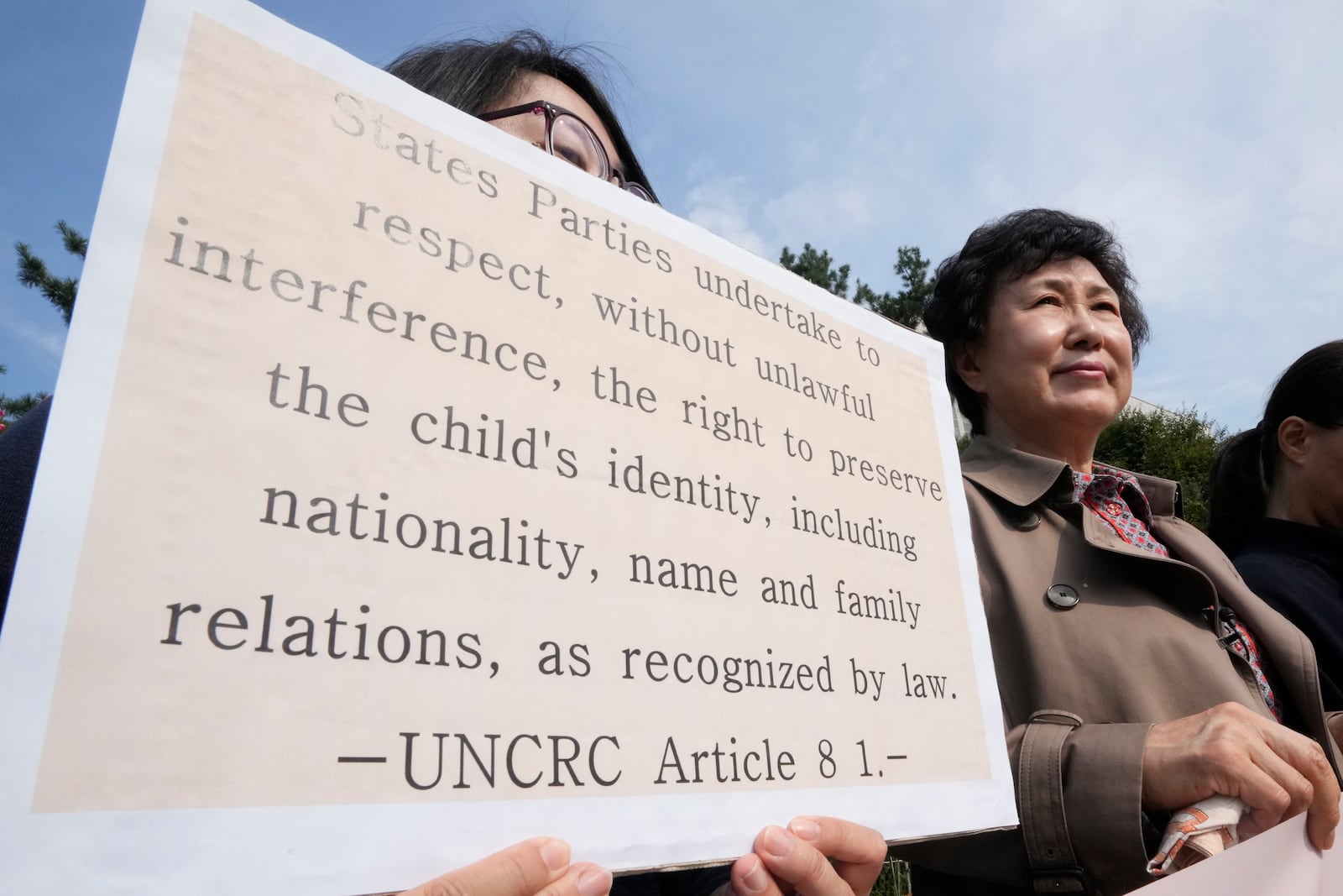 Han Tae-soon, right, attends a press conference in front of the Seoul Central District Court in Seoul, South Korea Monday, Oct. 7, 2024 before she sues her government, an adoption agency and an orphanage over the adoption of her daughter. (AP Photo/Ahn Young-joon)